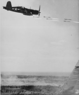 Corsair fighter looses its load of rocket projectiles on a run against a Japanese stronghold.